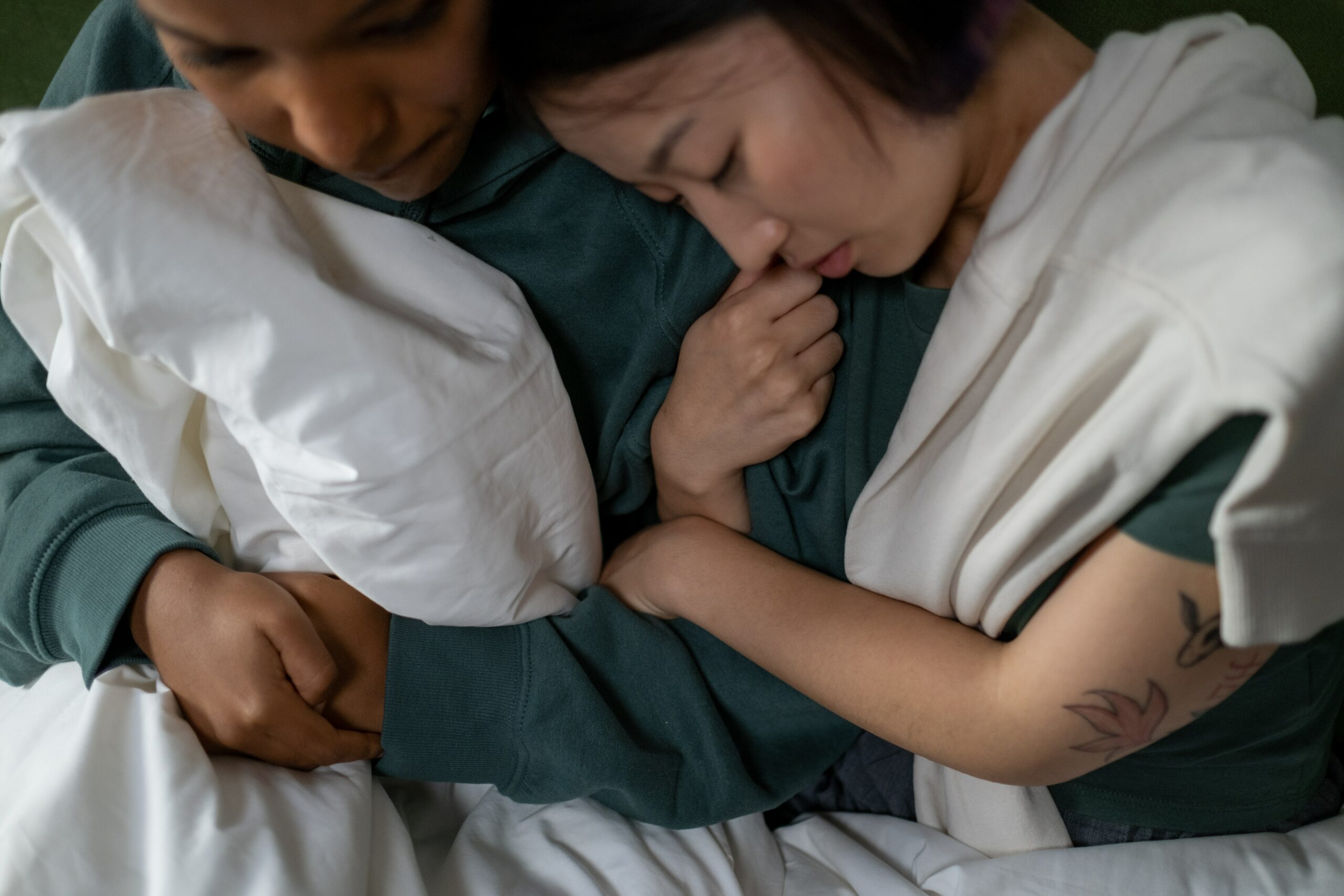 Two people hugging under blankets