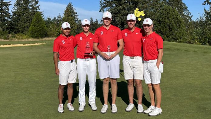 photo of the men’s golf team holding hardware.
