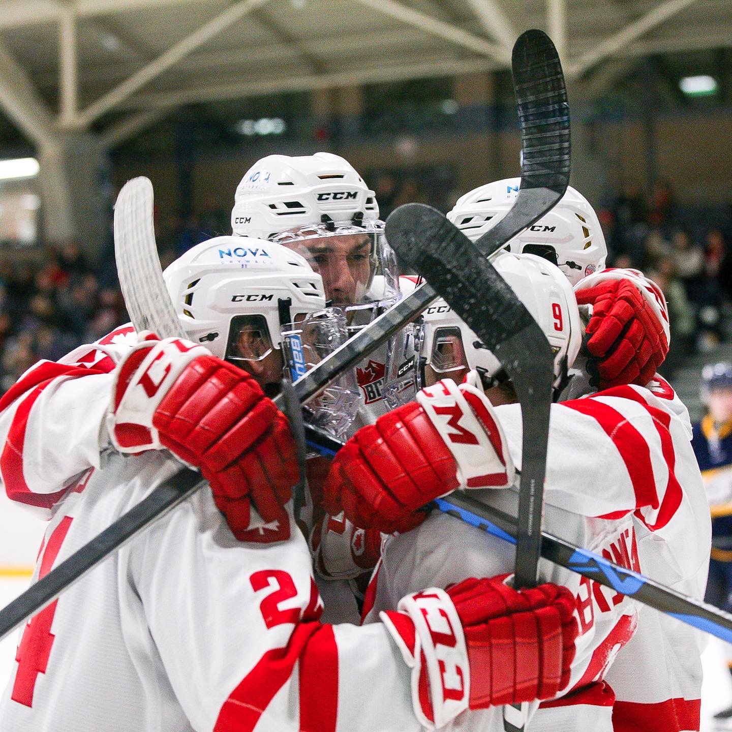 Photo of the SFU hockey team joining in the celebrations after a goal.