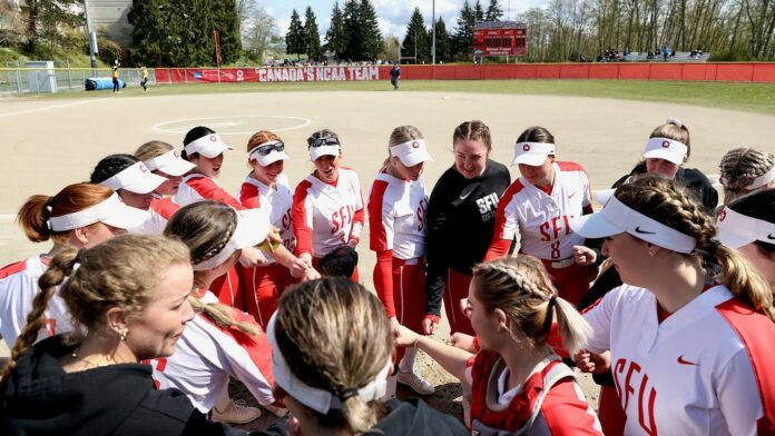 crop (2) photo of the SFU softball team in a huddle.