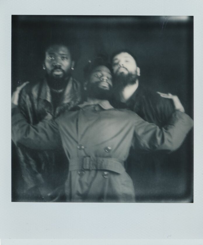 Young Fathers in a black and white polaroid photo.