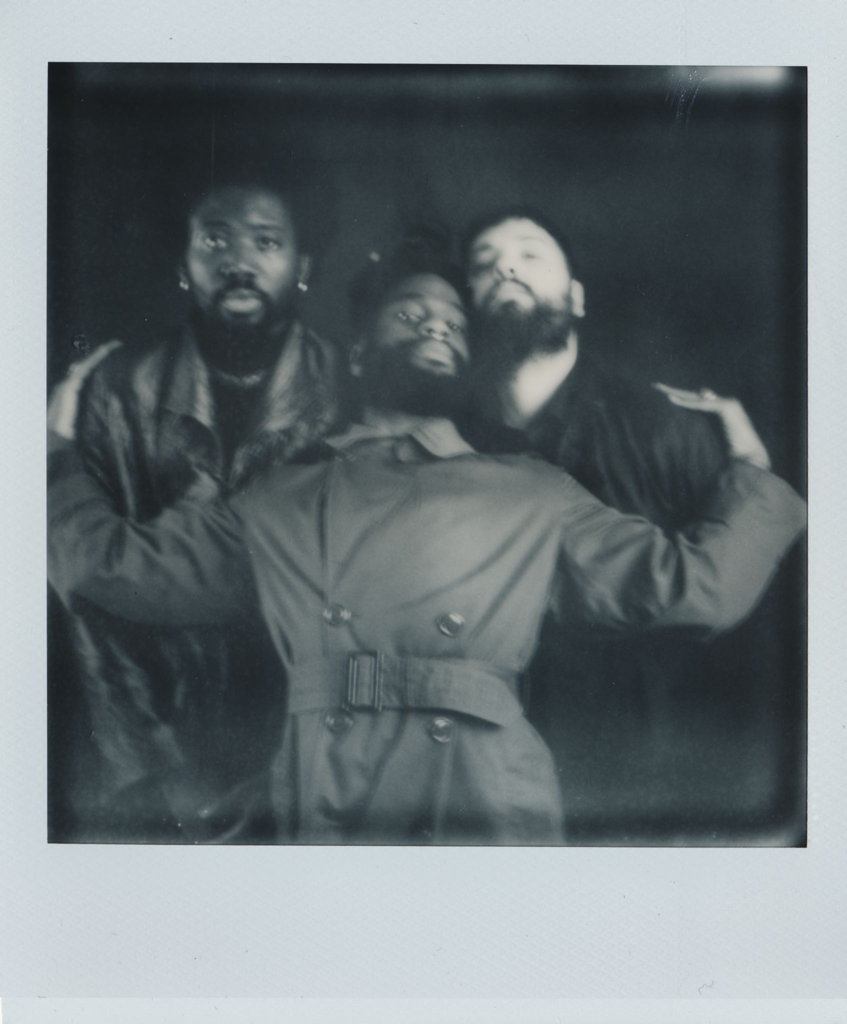 Young Fathers in a black and white polaroid photo.