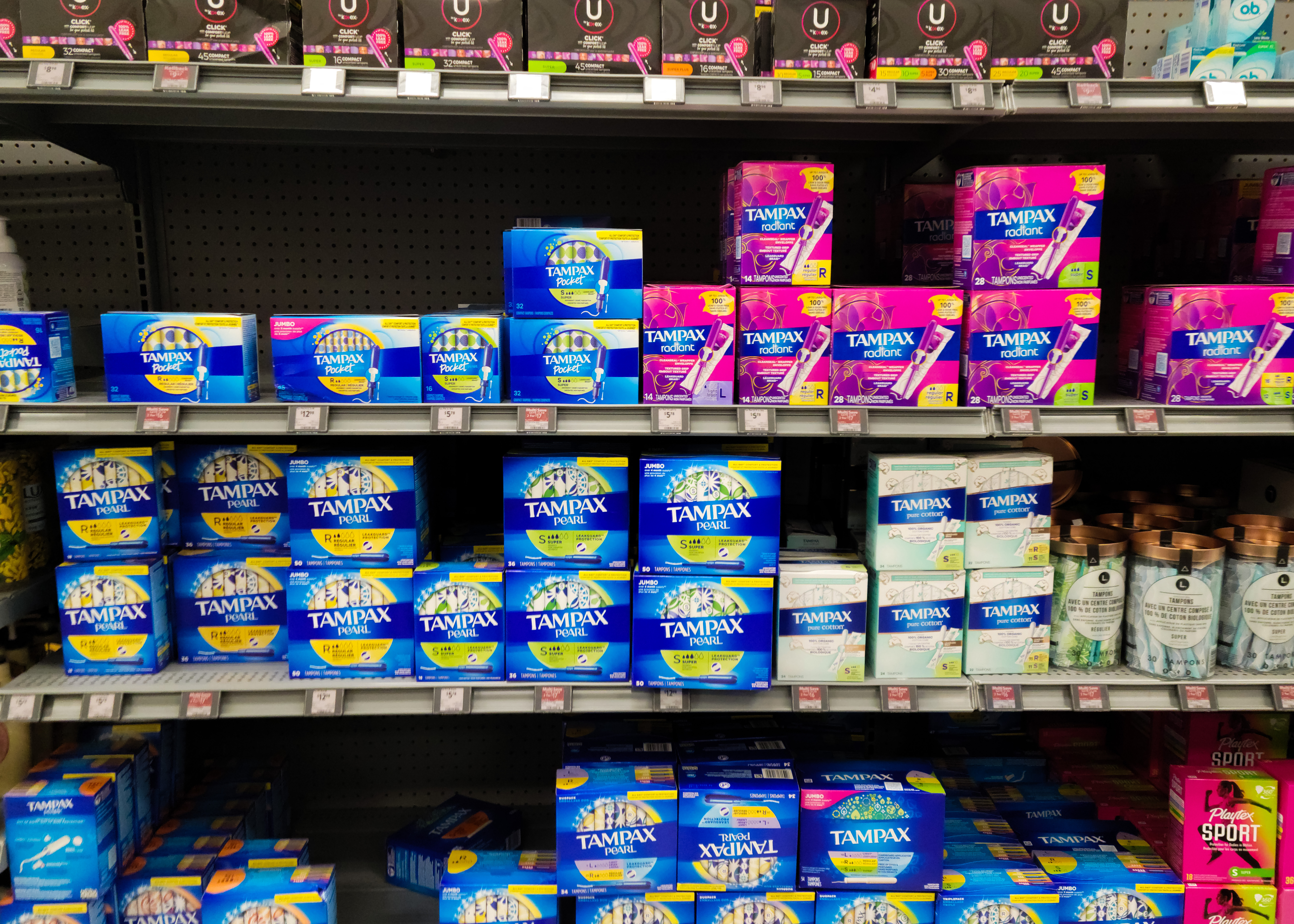 This is a photo of tampon boxes on the shelf at a store.