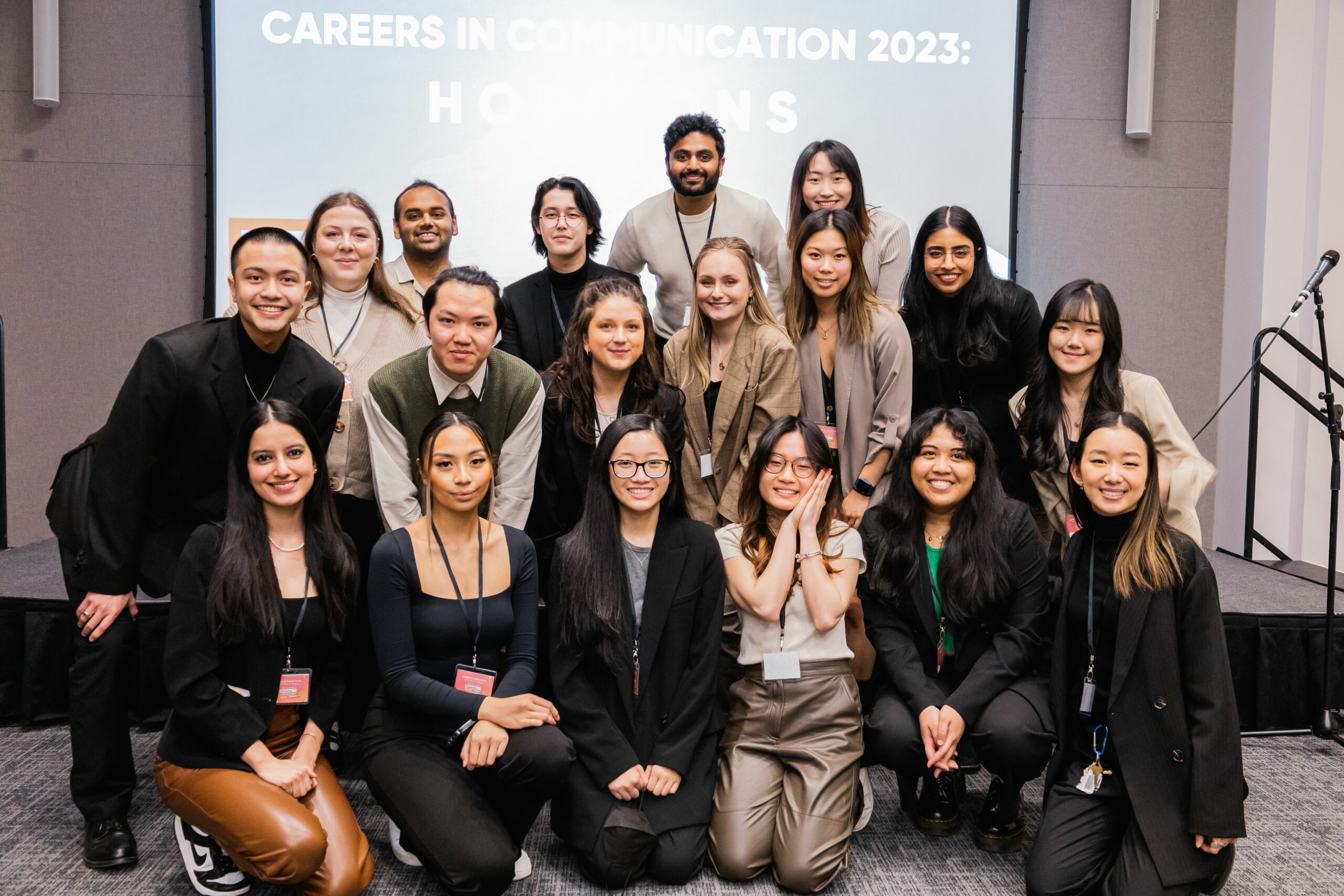 This is a photo of the communication student union executive board. The students are huddled together and smiling for the camera