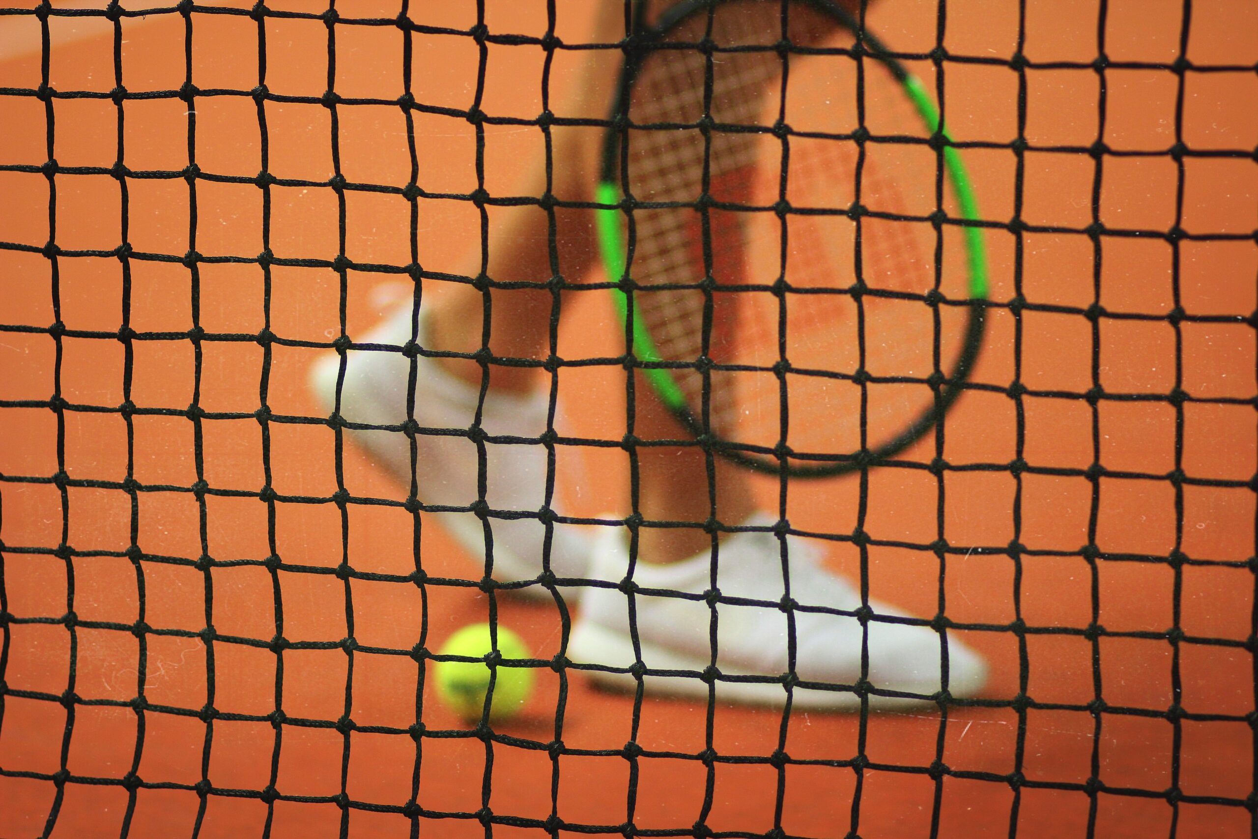 photo of a player walking across a tennis court.