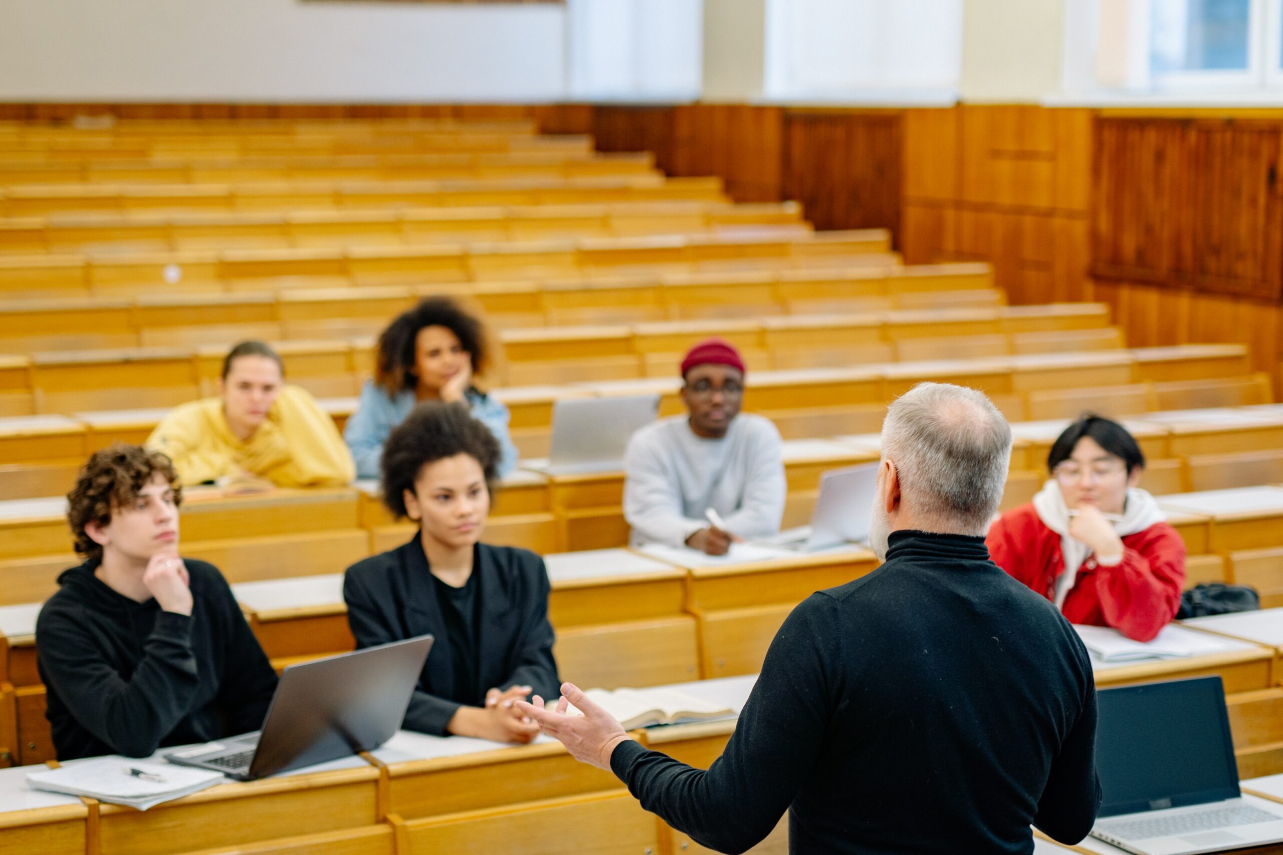 This is a photo of a lecturer standing in a lecture hall speaking to students