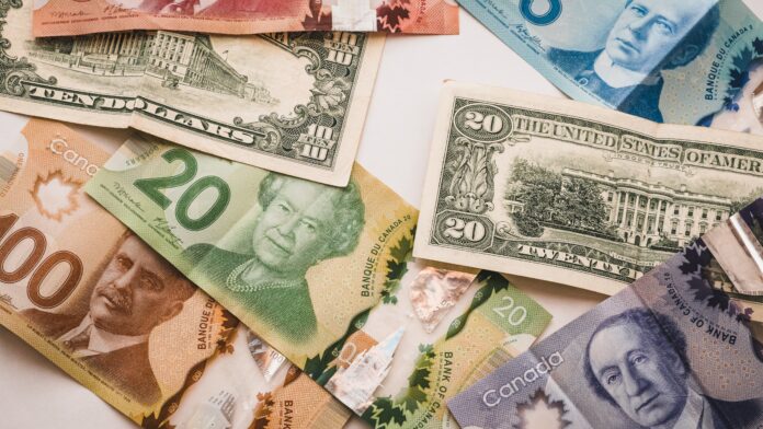 A photo of different denomination bills from both Canada and the United States