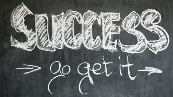 A blackboard with “SUCCESS go get it” written on it with white chalk