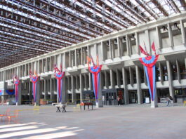 A photo of convocation mall at SFU Burnaby Campus, Ribbons hanging from the walls can be seen.