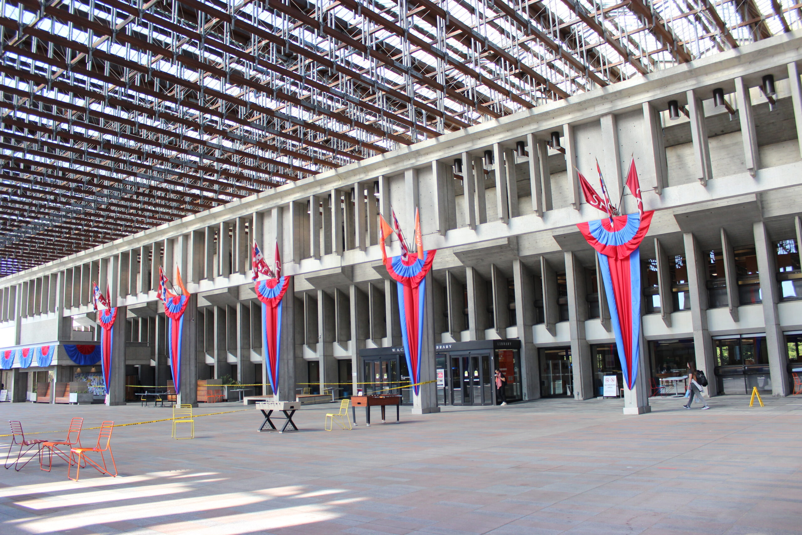 A photo of convocation mall at SFU Burnaby Campus, Ribbons hanging from the walls can be seen.