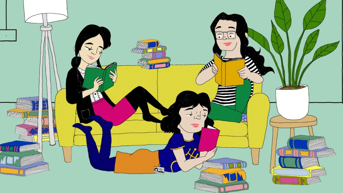 An illustration from the graphic novel of 3 South east asian women reading books. Two of them are sitting on a yellow couch, and one is sprawled on the floor. They are surrounded by books, and a sage green background, with a plant and a lamp beside them. They’re dressed in colourful, business casual clothes, including a striped shirt, deep blue tights under an orange pencil skirt, and a black blazer.