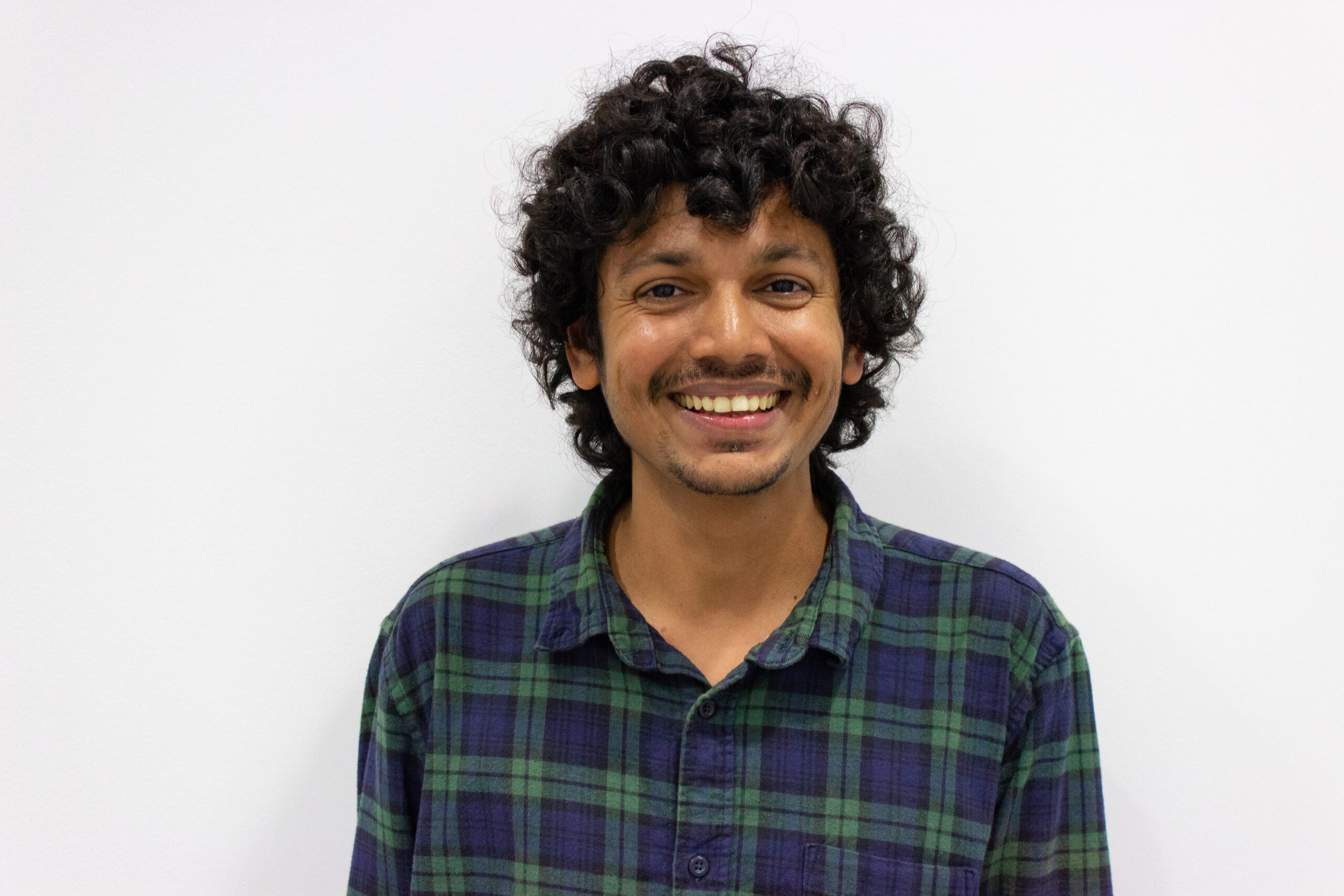 This is a photo of Dr. Ajmal Khan A. T. This headshot depicts Dr. Khan staring into the camera, smiling.