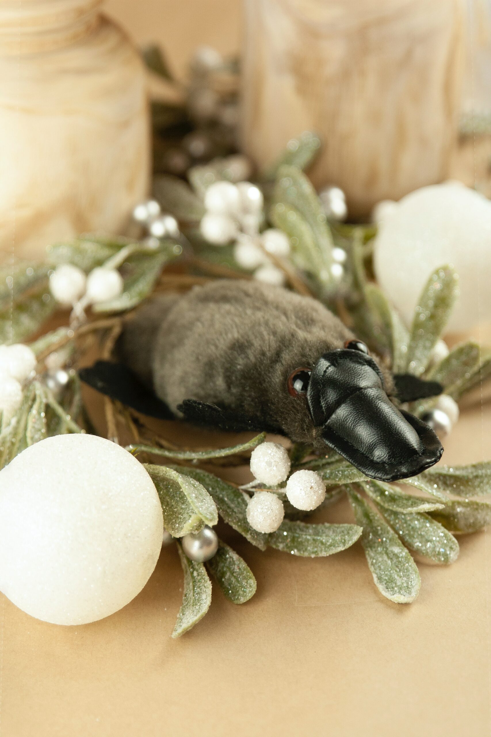 Platypus toy surrounded by artificial mistletoe