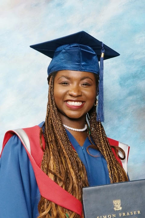 In photo, Des'ree Isibor in a blue graduation gown and red details holding a diploma