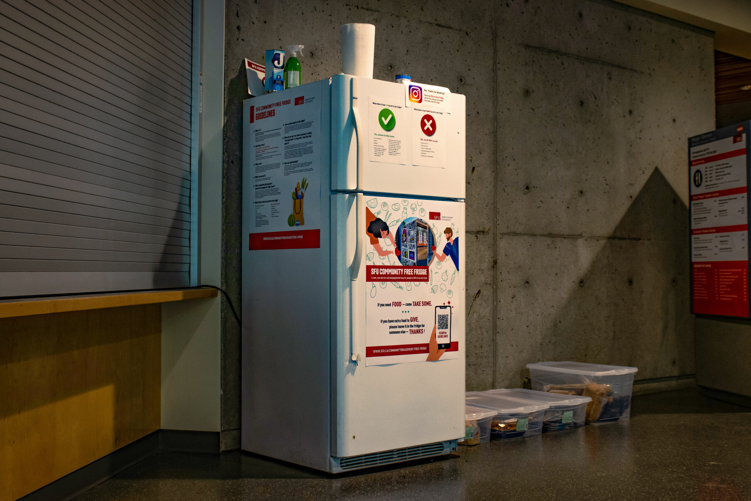 A photo of a fridge in a dimly lit room.