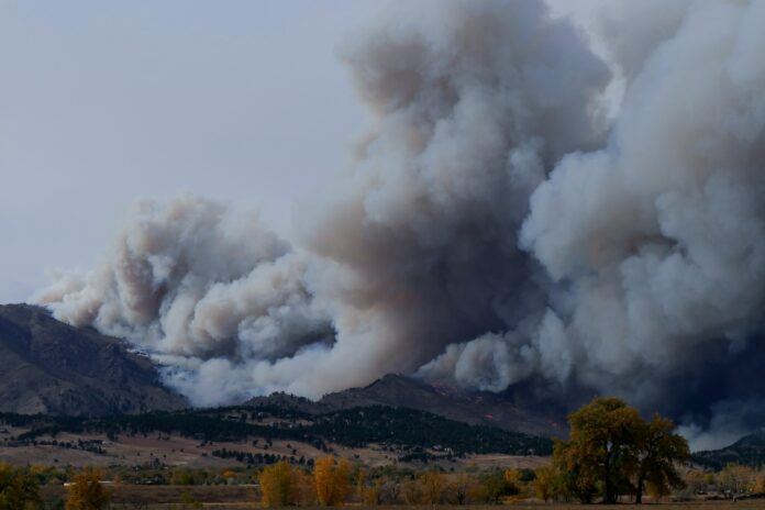mountains in the background with columns of smoke