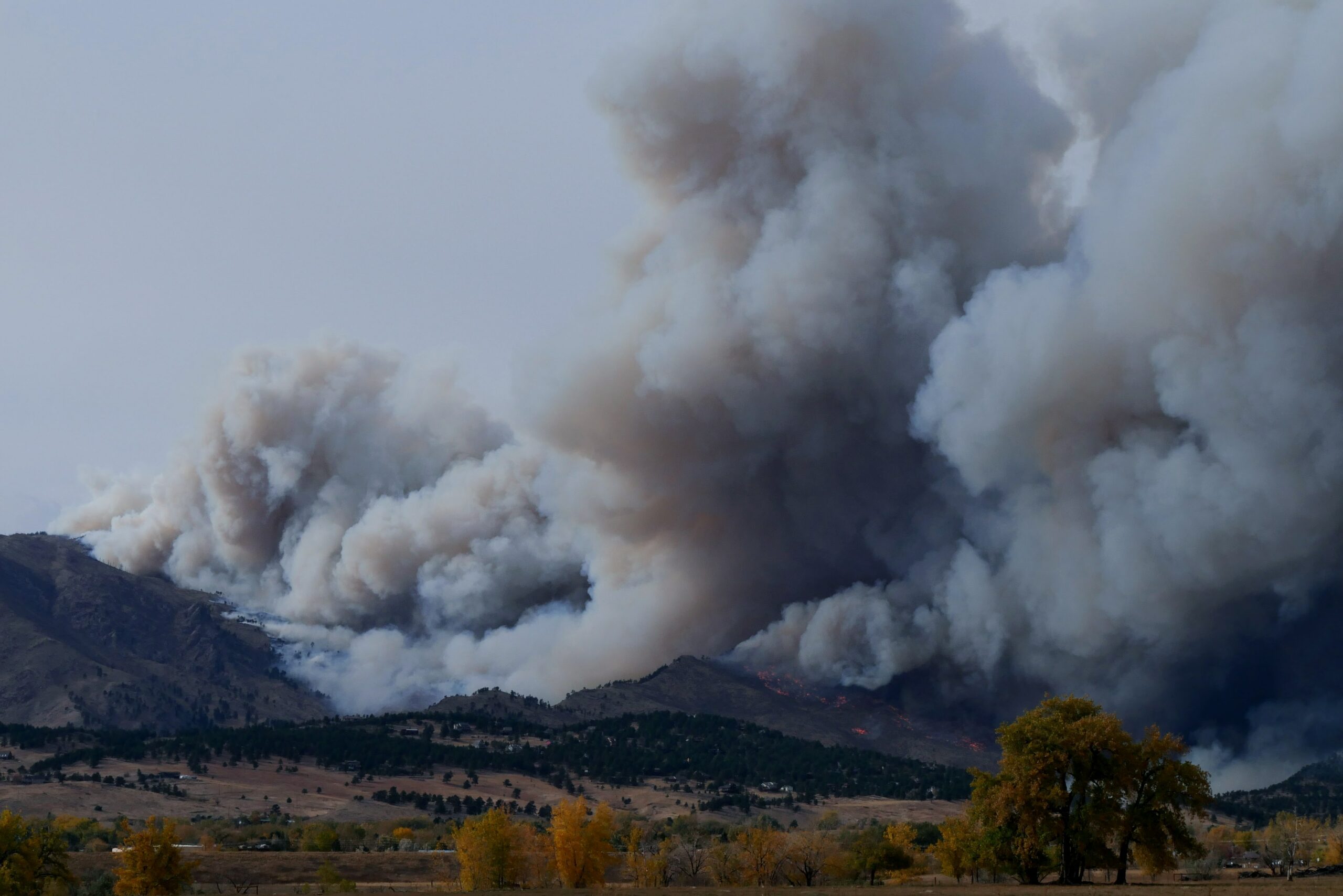 mountains in the background with columns of smoke