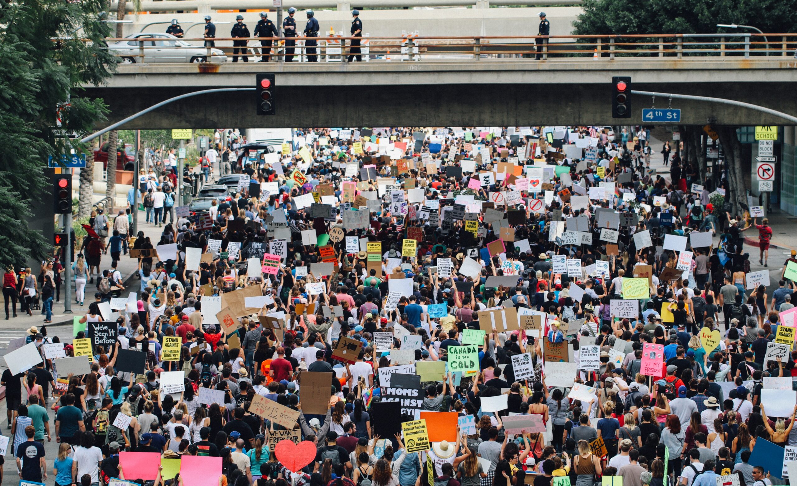 Photo of protestors blocking a road and holding signs against racism