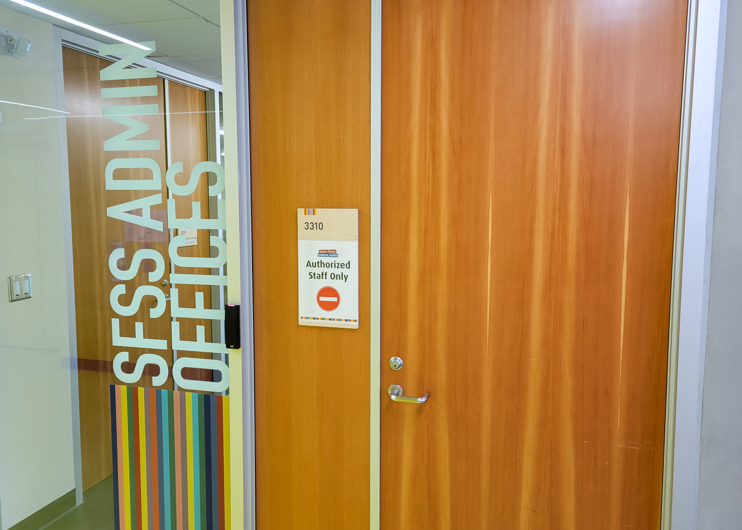 This is a photo of the outside of the SFSS offices in the Student Union Building. On the window there is a sign that reads “SFSS Admin Offices, authorised staff only.”