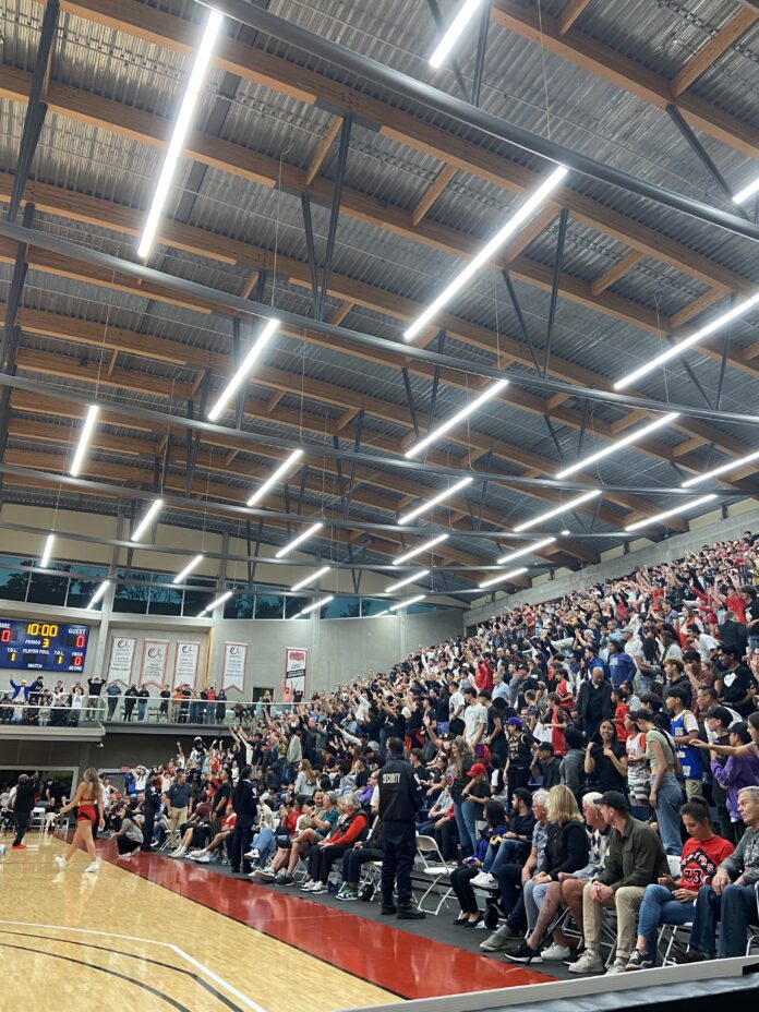 raptorspractice2 Pictured, the right side of the basketball court at SFU. Fans raise their arms up in anticipation.
