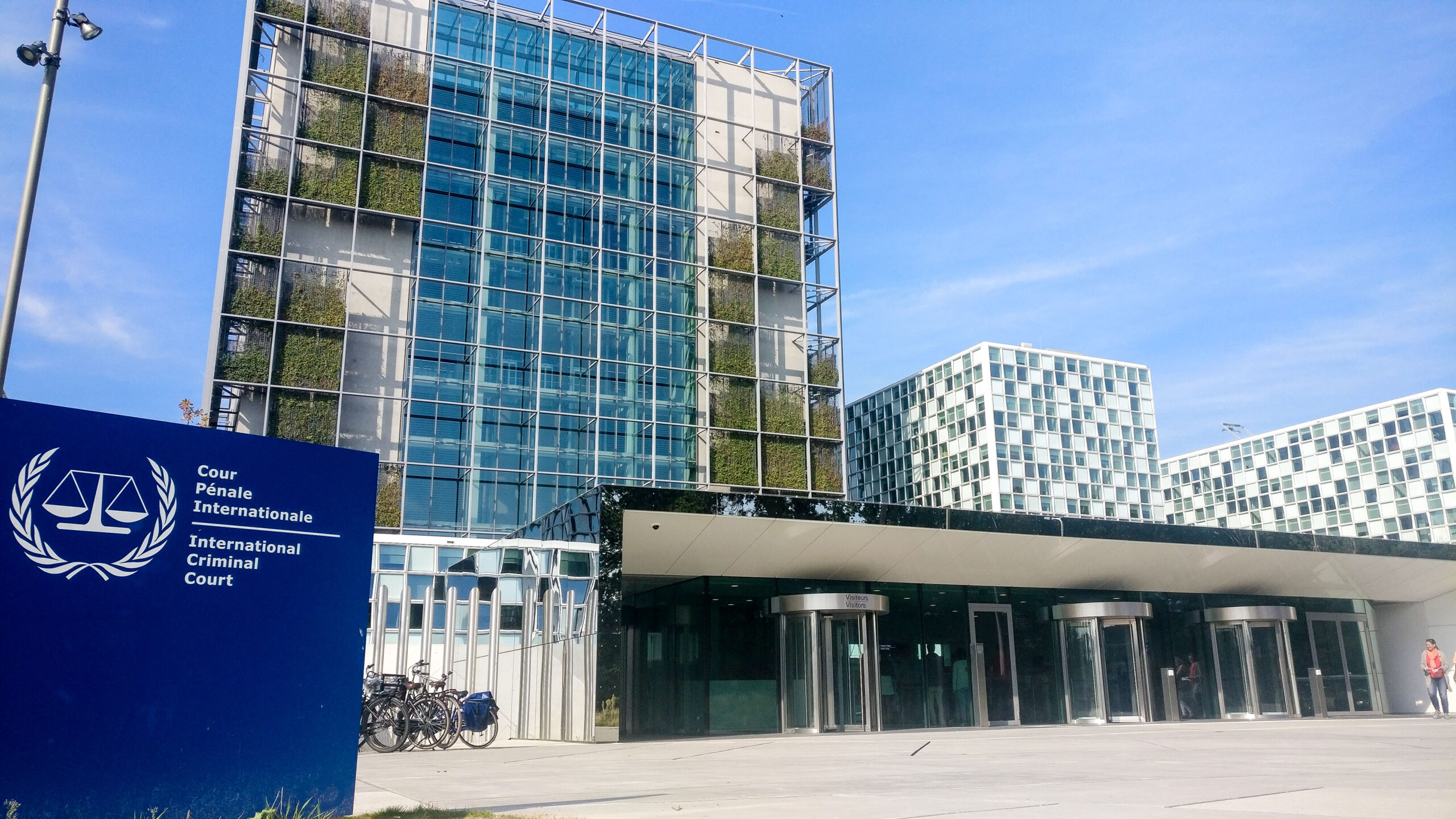 This is a photo of the International Criminal Court building in Geneva. The sign is clearly visible, in front of the building.