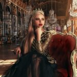 Peakie is here to help you navigate injustice Woman wearing a gown and a crown sitting in an ornately decorated room