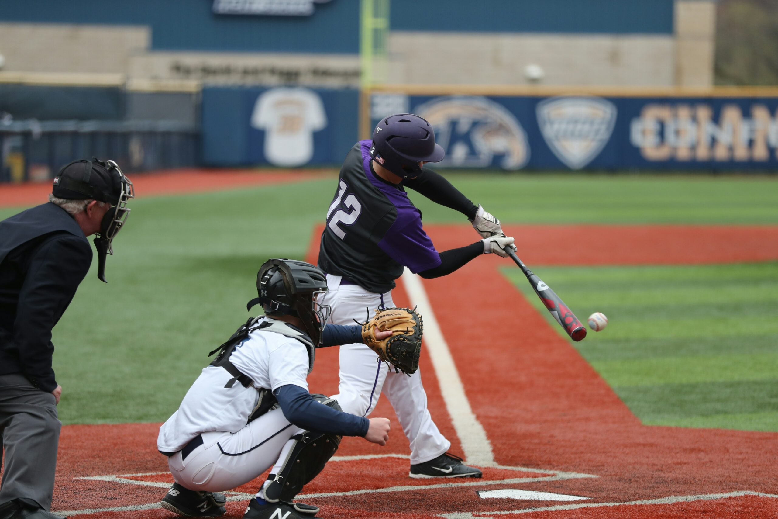 photo of a baseball player at the plate, swinging their bat.