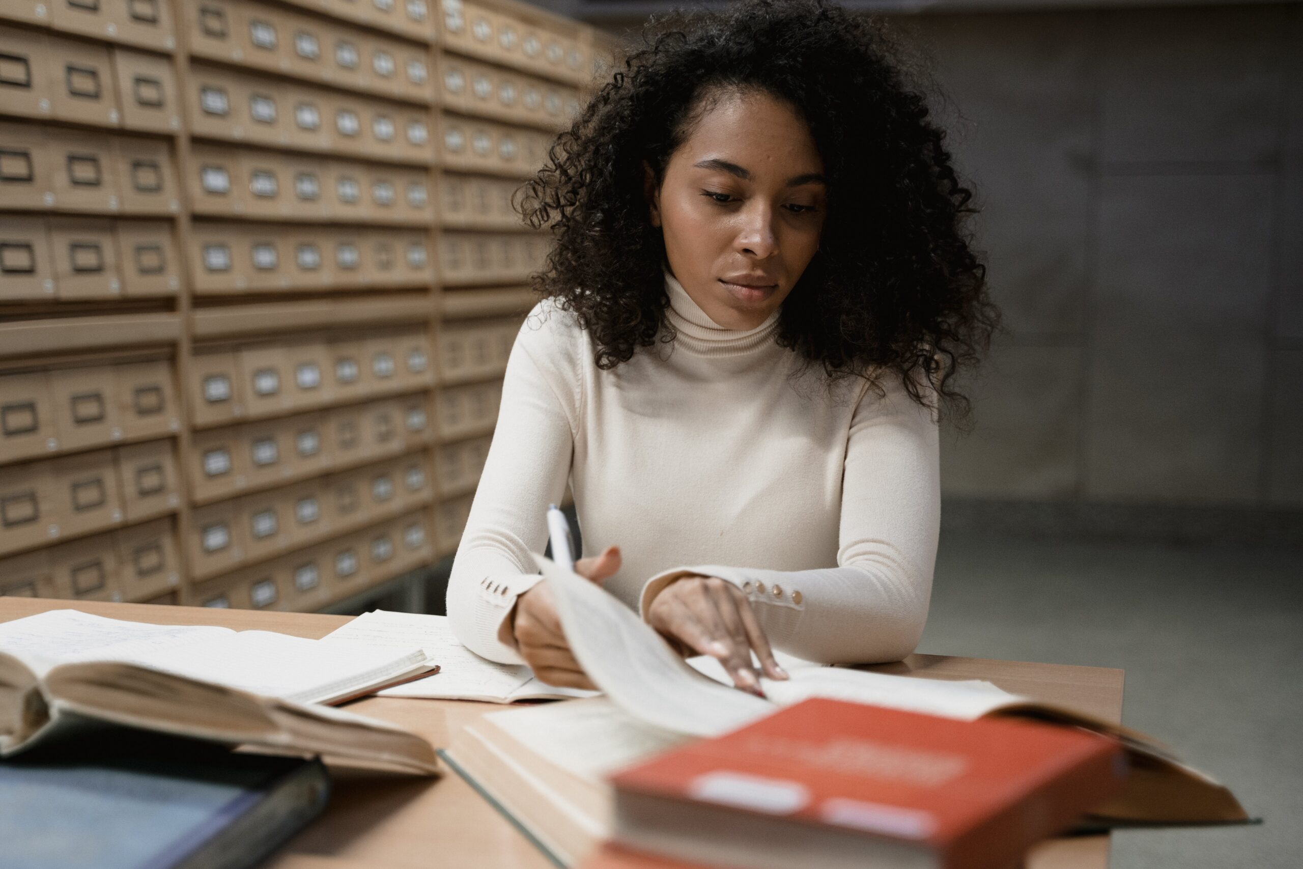 A Black woman reading a book