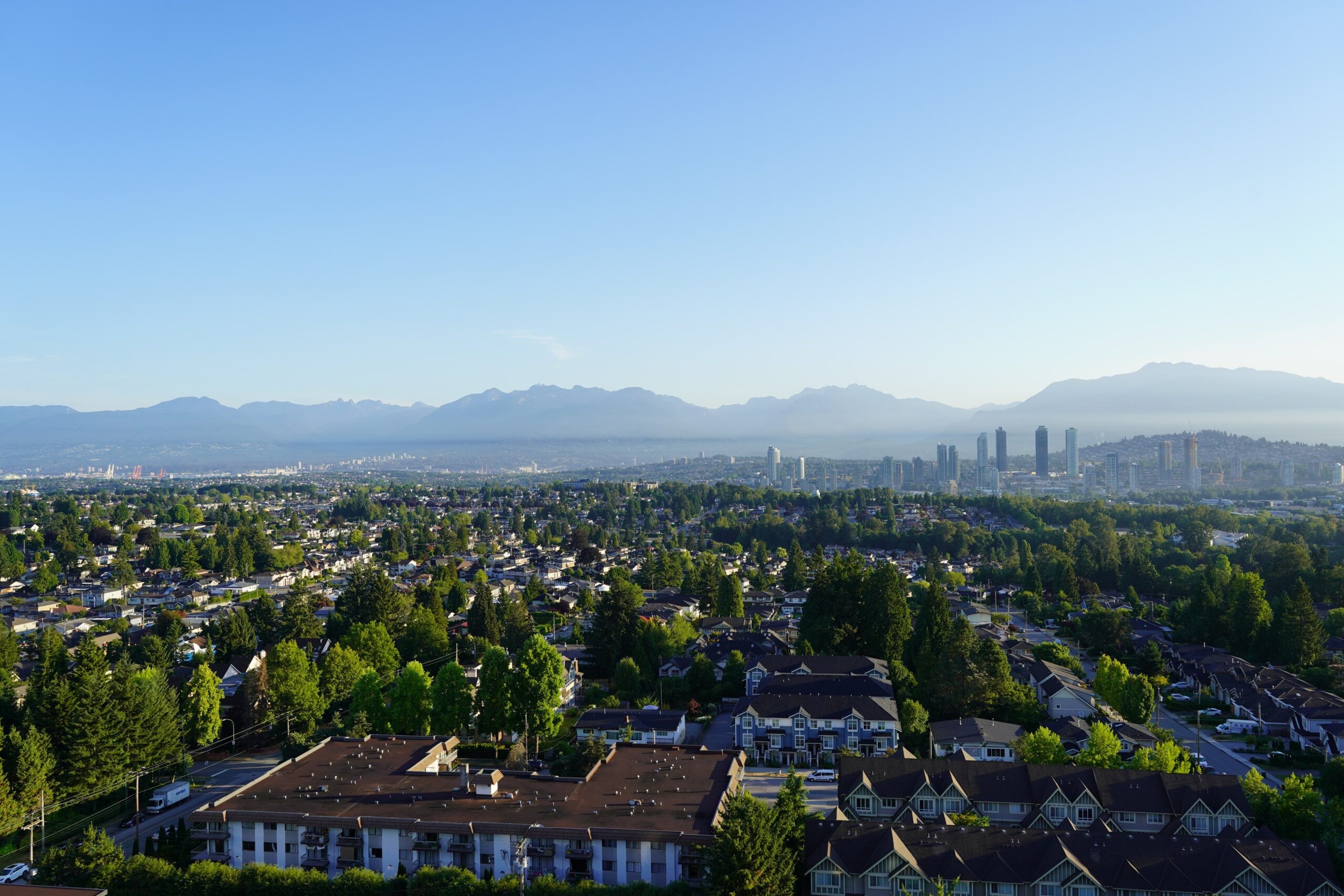 This is a photo of the suburbs in Burnaby, Canada. This is a large aerial shot, where suburbian houses and trees spread as far as can be seen.