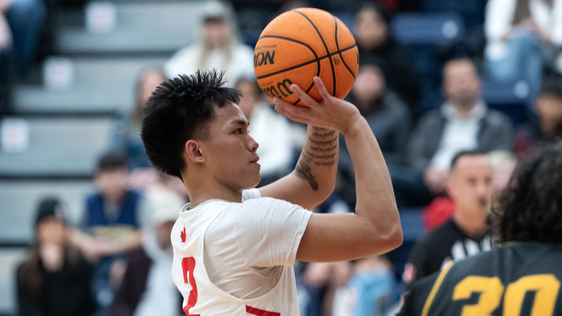 photo of an SFU men’s basketball player at the free throw line.