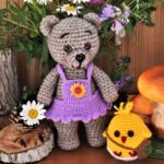 Peakie gets real Stuffed crochet bear and chick surrounded by fake plants.