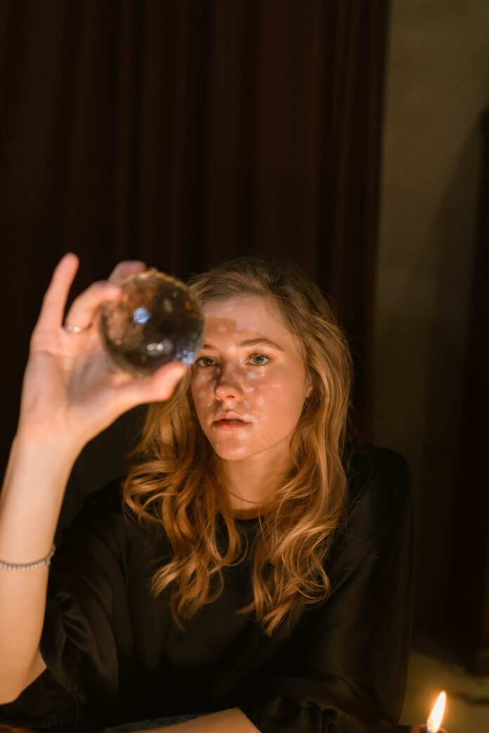 A woman holding a crystal ball.