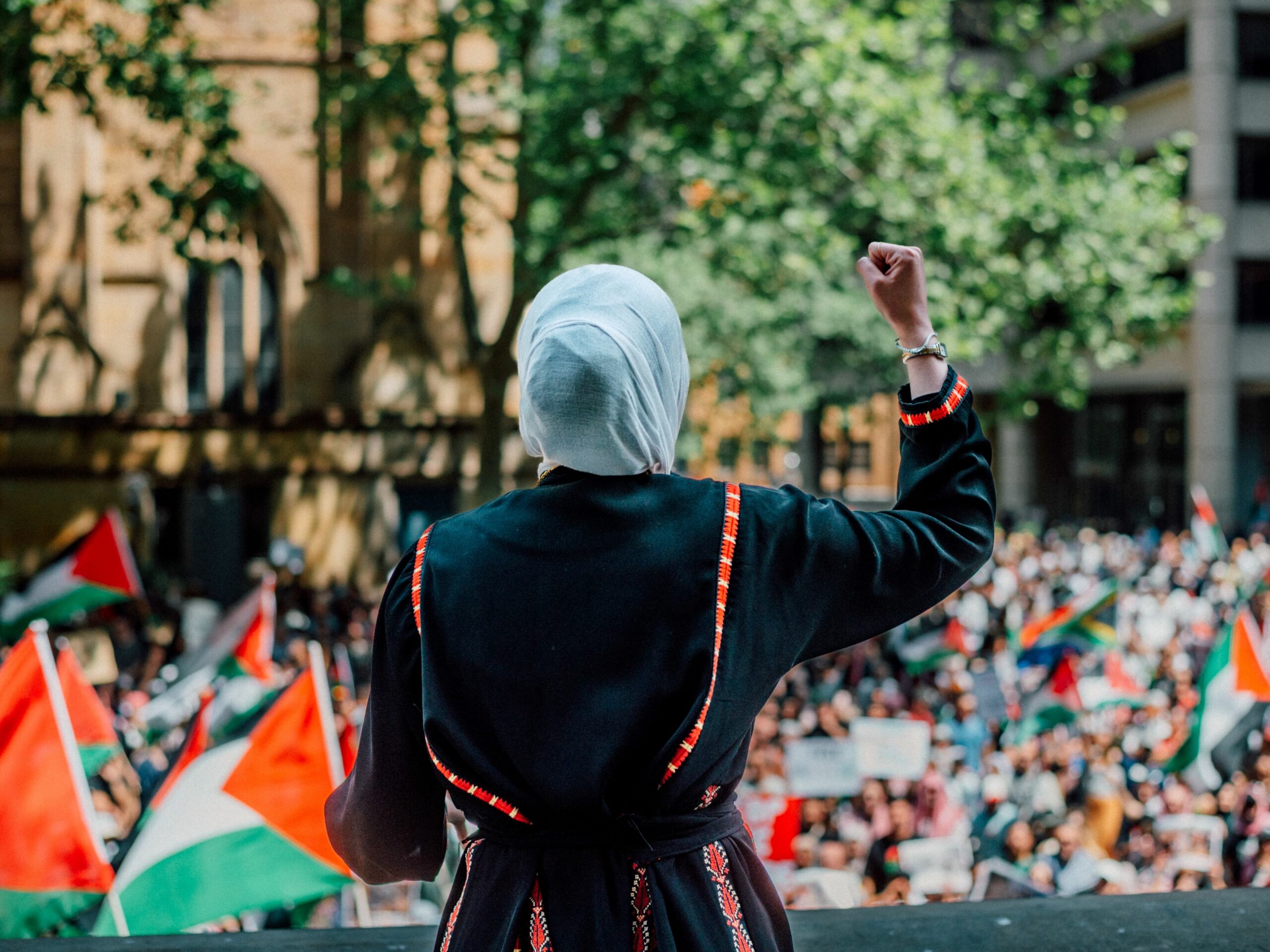 A woman leading a protest for Palestinian liberation