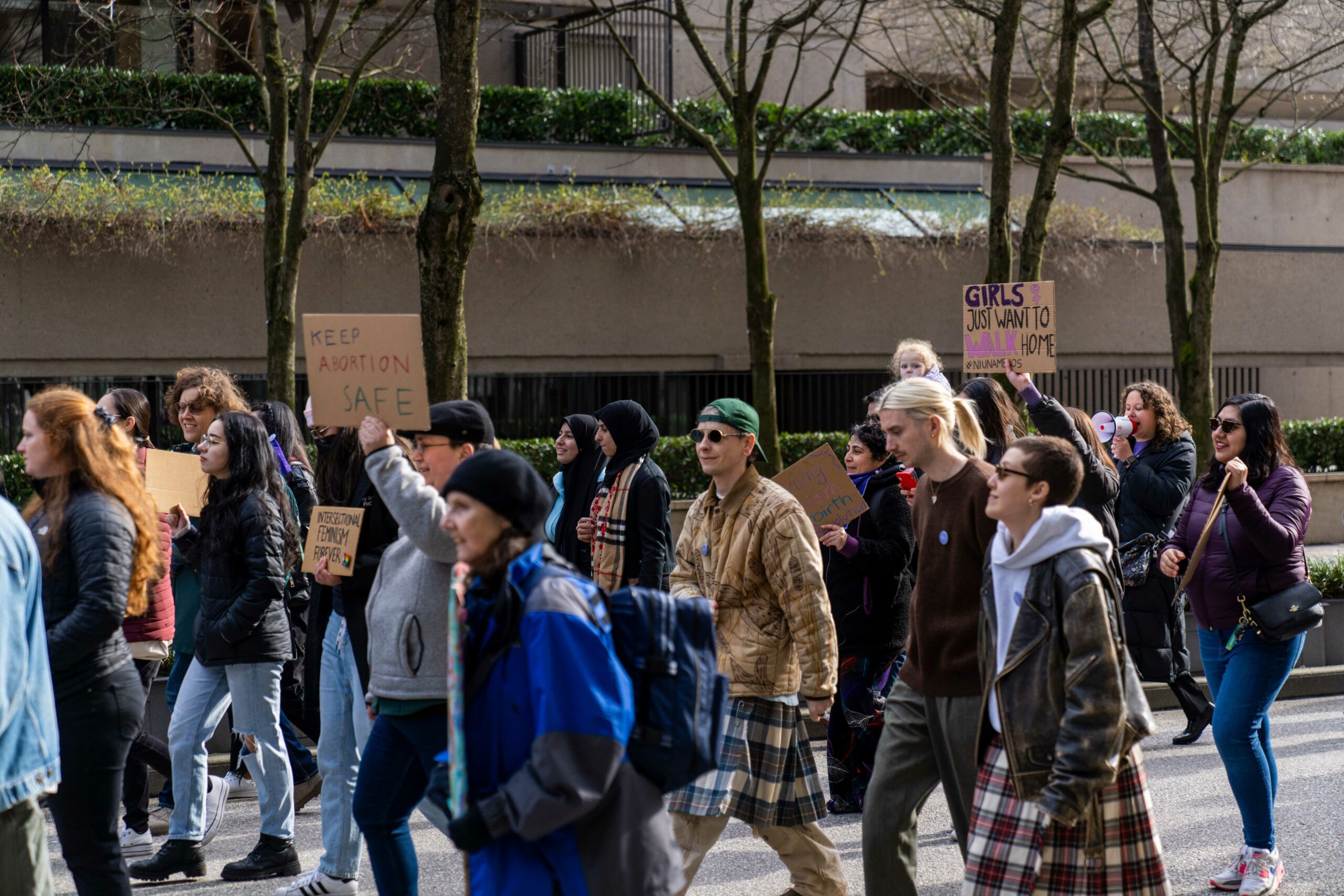 This is a photo from the previous year’s rally. There are folks in the street, walking with signs.