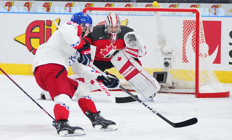 Czechia player on their backhand driving to the Canadian net.