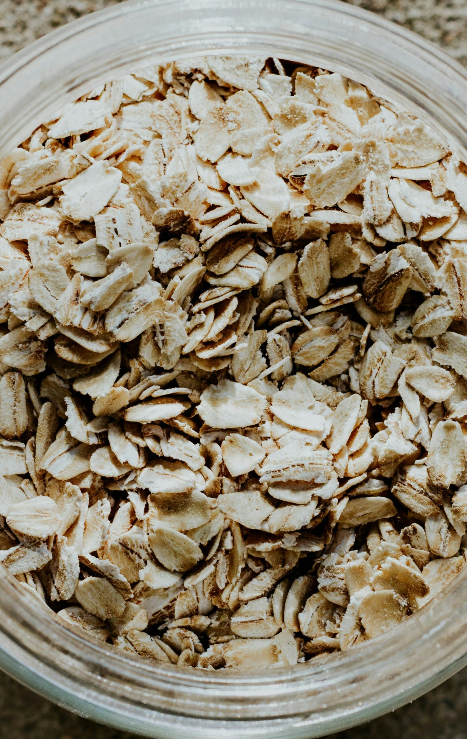 Close up of a clear plastic container filled with oats.