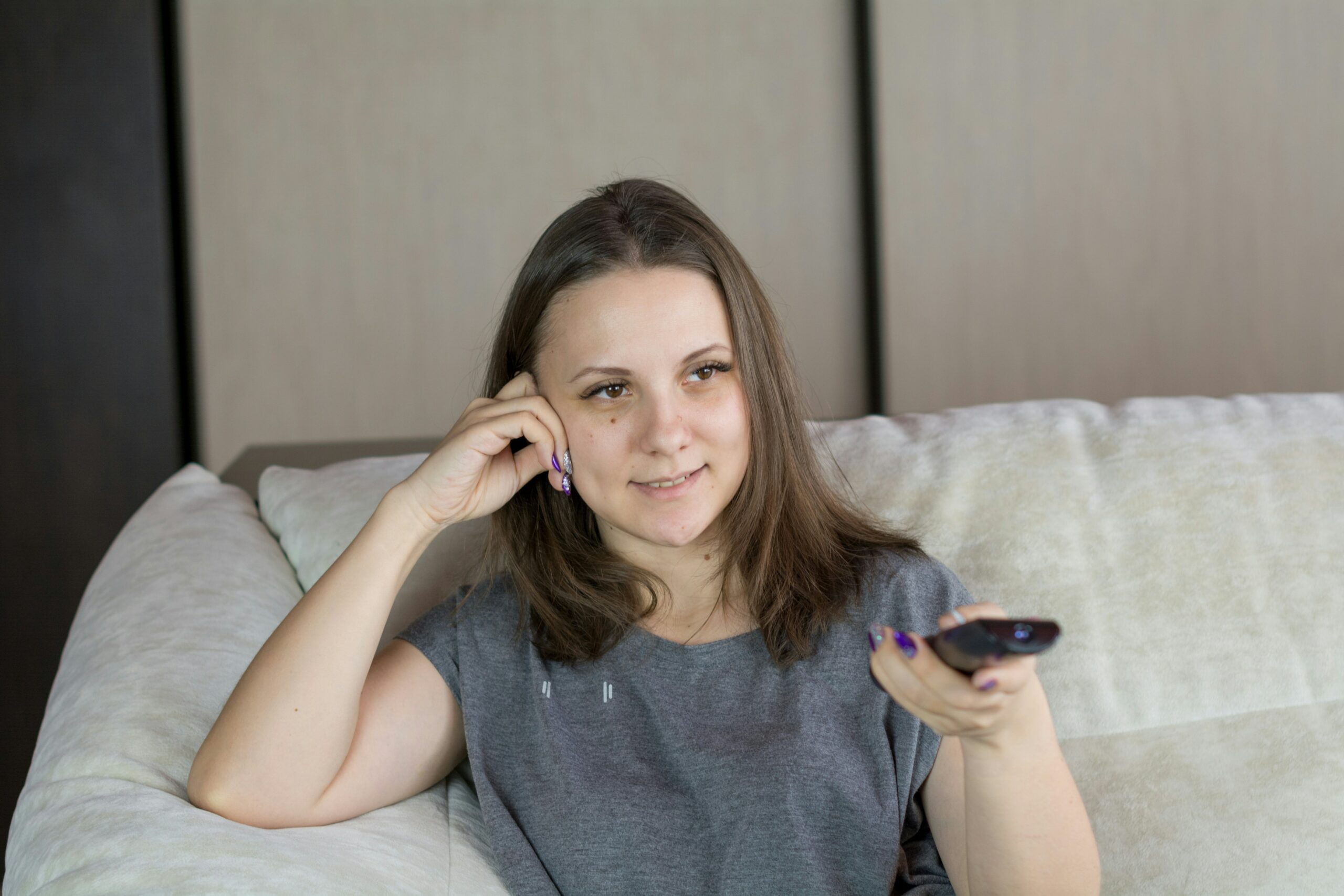 A person holding a TV remote.