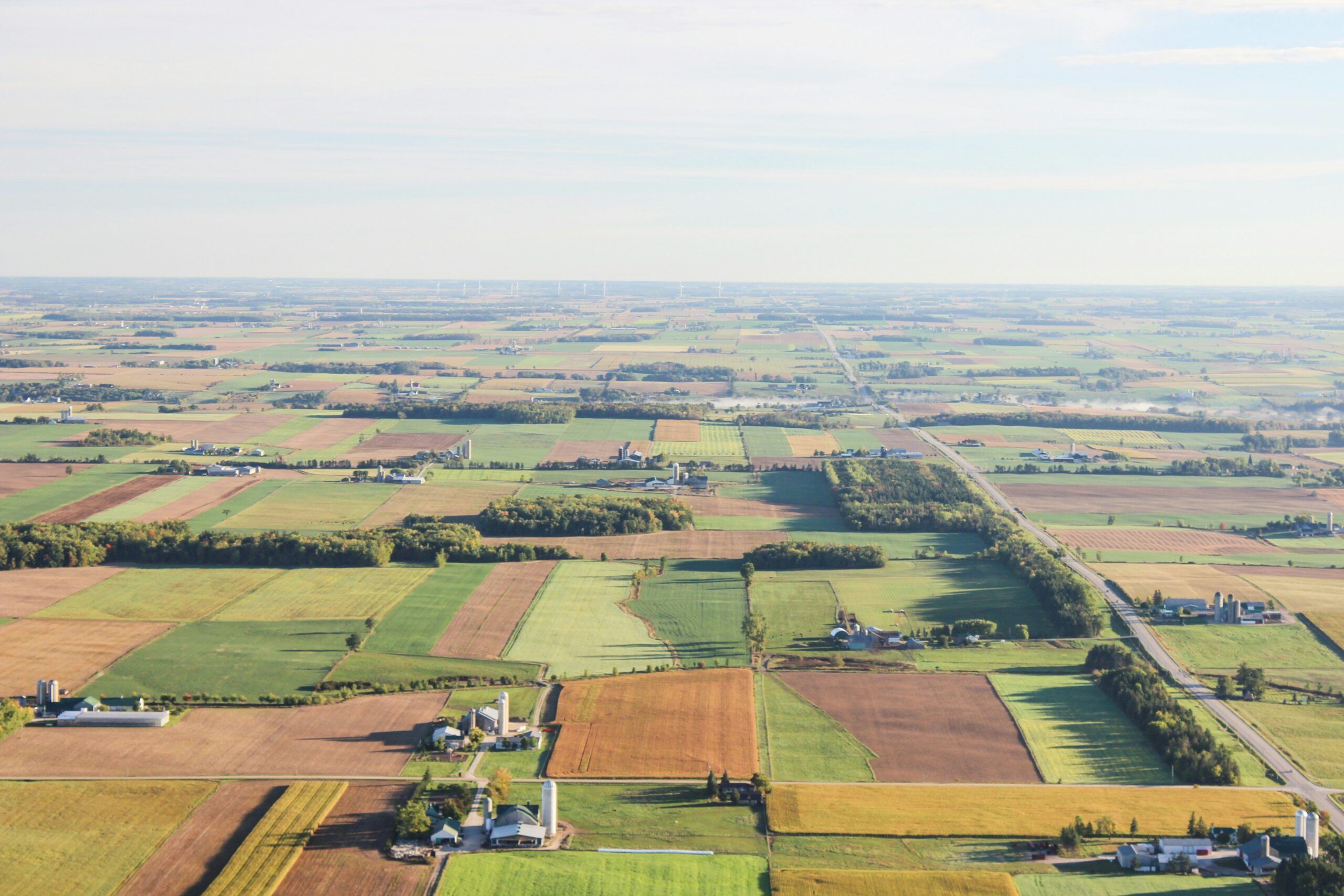 This is an aerial photo of farming land in BC. There are numerous properties and farming plots.
