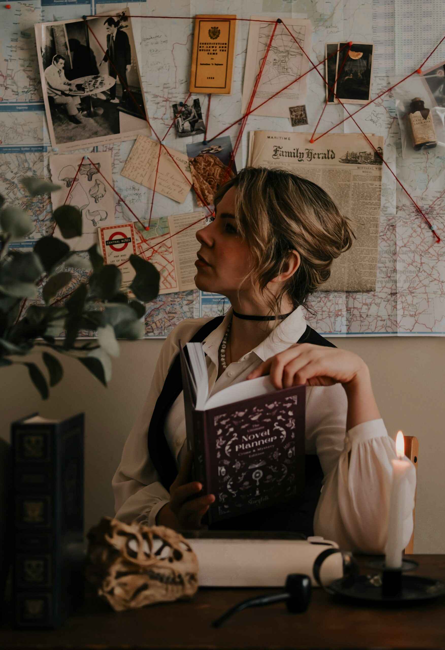 Woman sitting in front of an investigation board.