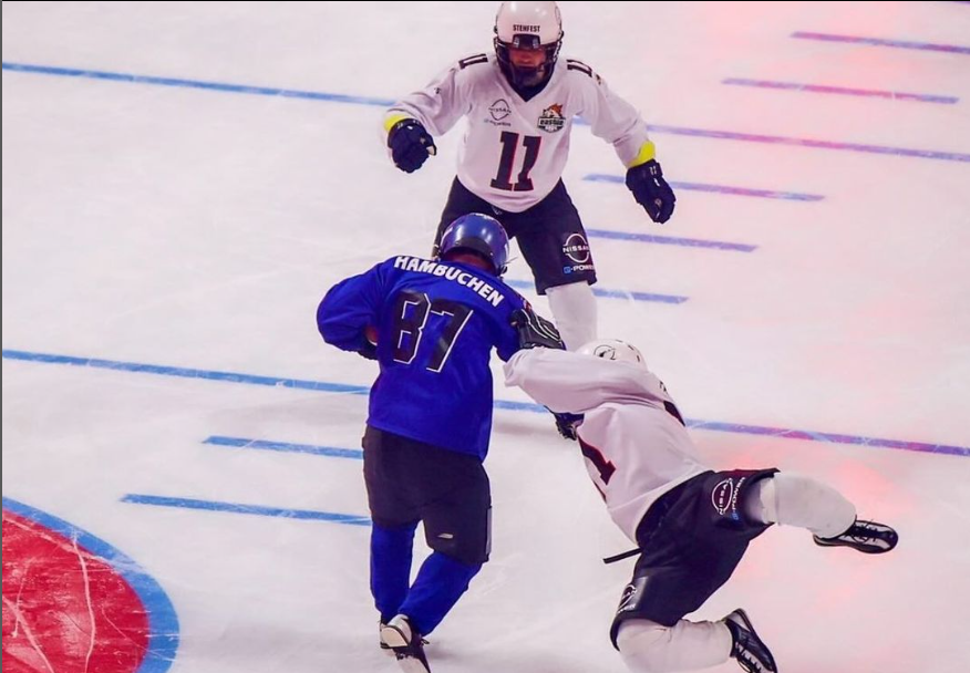 Players trying to run across the ice in football gear to play american ice football