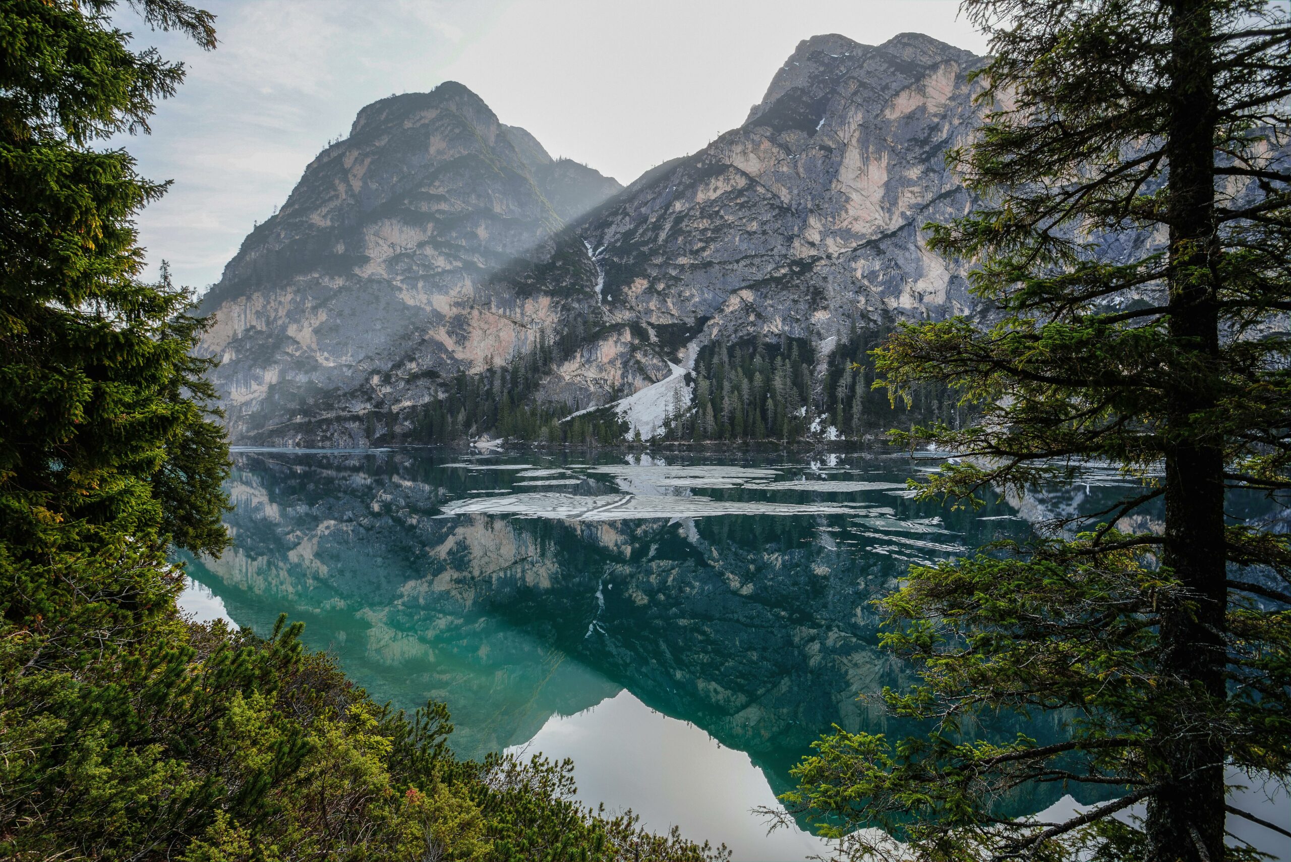 Mountains near a body of water. The reflection of the mountains is visible in the water.