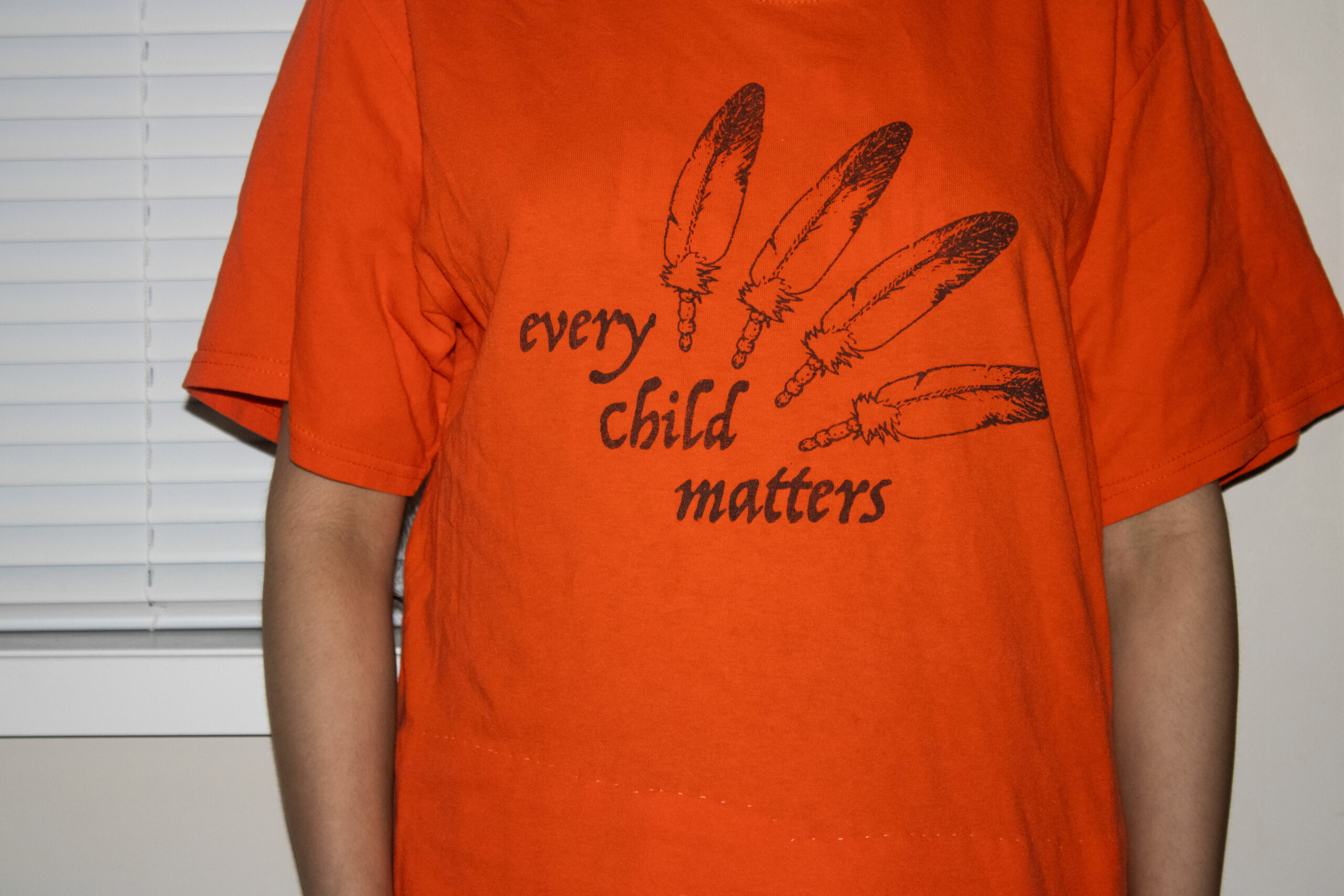 an orange every child matters shirt