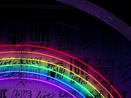 a rainbow light that illuminates phrases such as “love is a human right” and “love is love.”