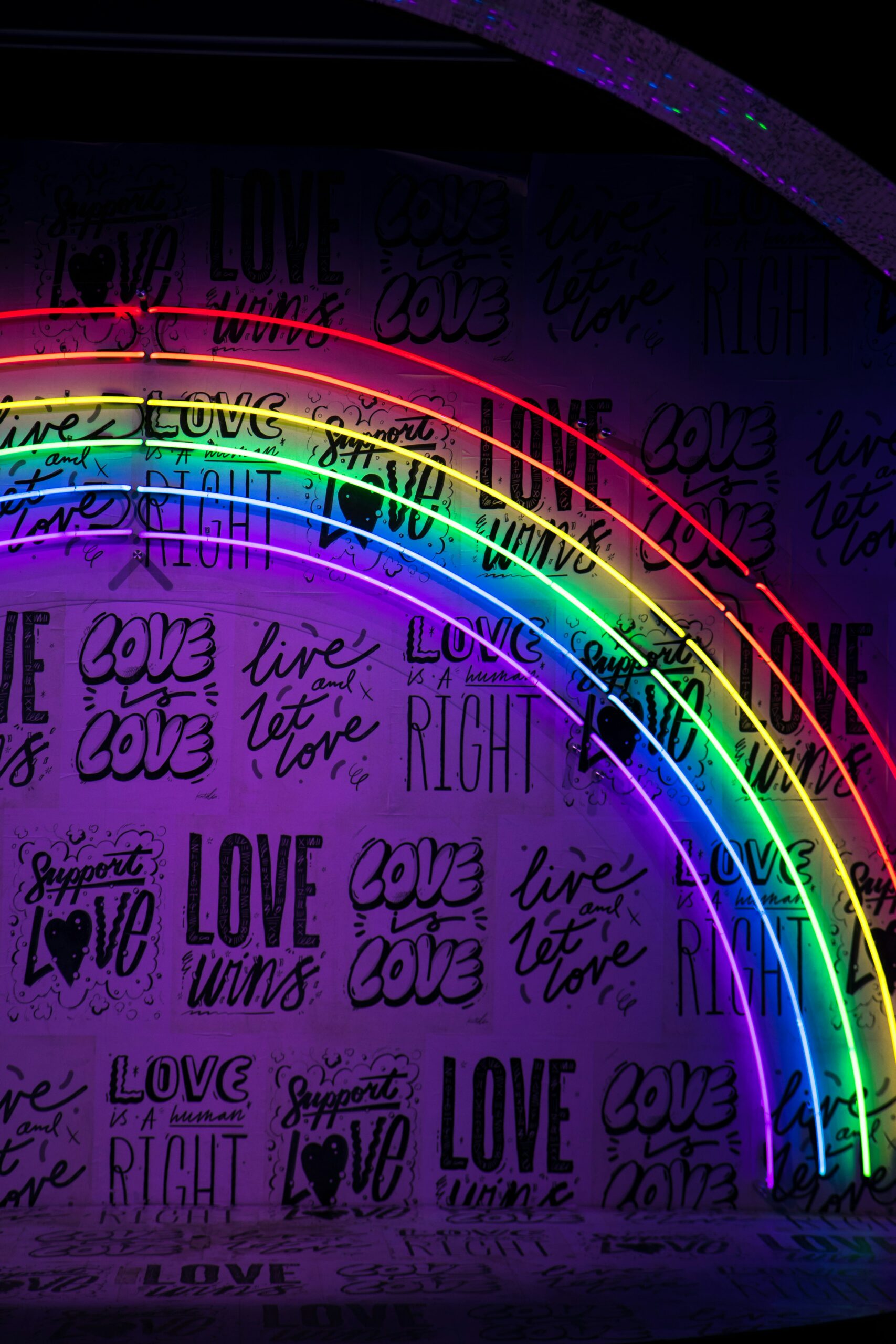 a rainbow light that illuminates phrases such as “love is a human right” and “love is love.”