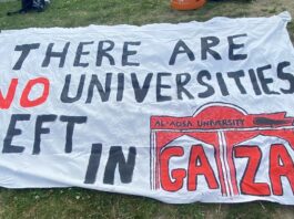 a handwritten banner saying "THERE ARE NO UNIVERSITIES LEFT IN GAZA"