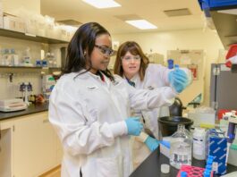 This is a photo of two women in a science lab working together