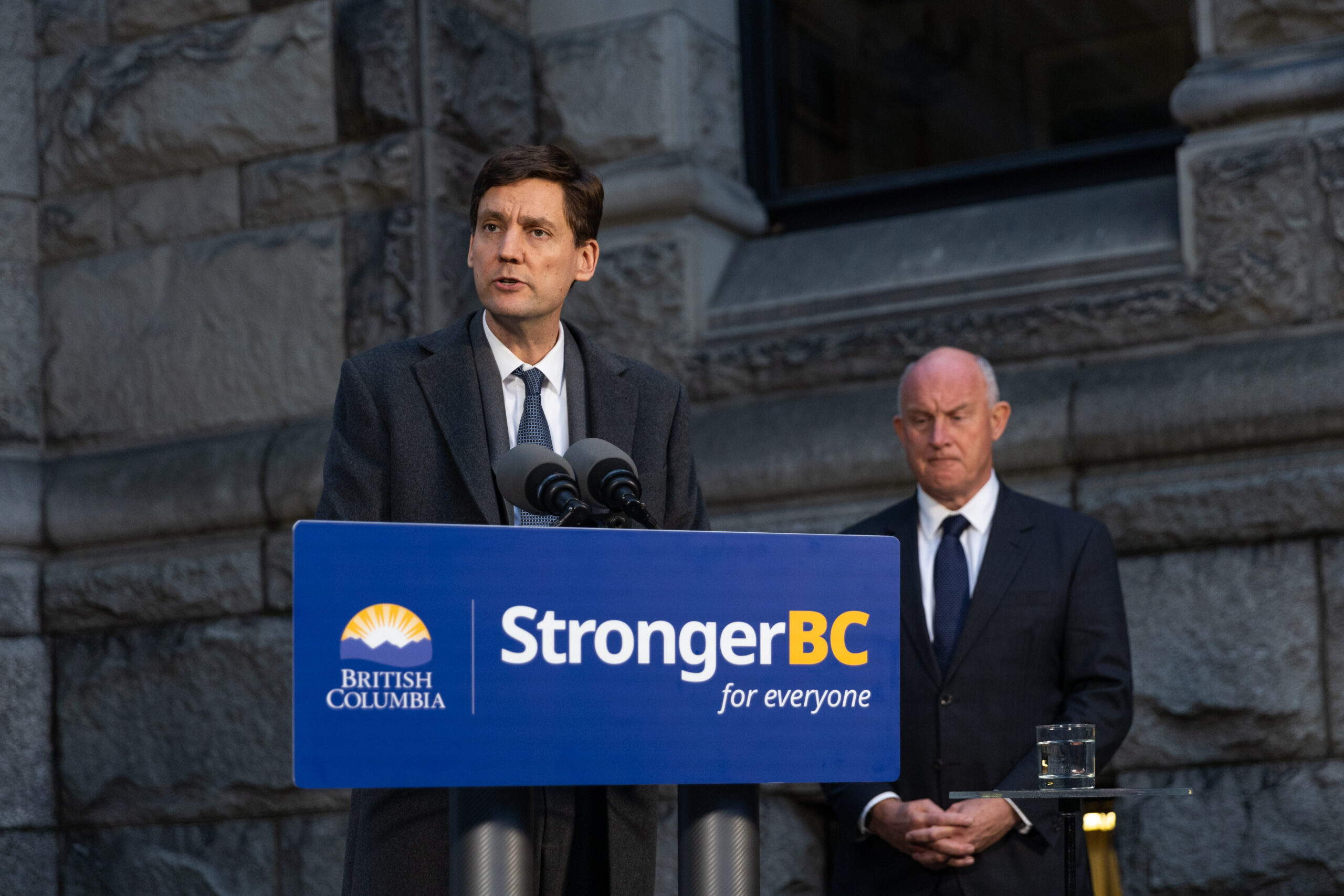 This is a photo of David Eby speaking in front of a podium that says “StrongerBC for everyone.”