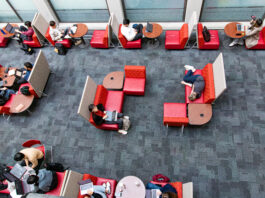 This is a photo of an SFU student in West Mall Centre pretending to be sleeping for the photo.