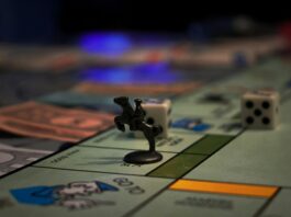 Monopoly board with a black racehorse token sitting on a square