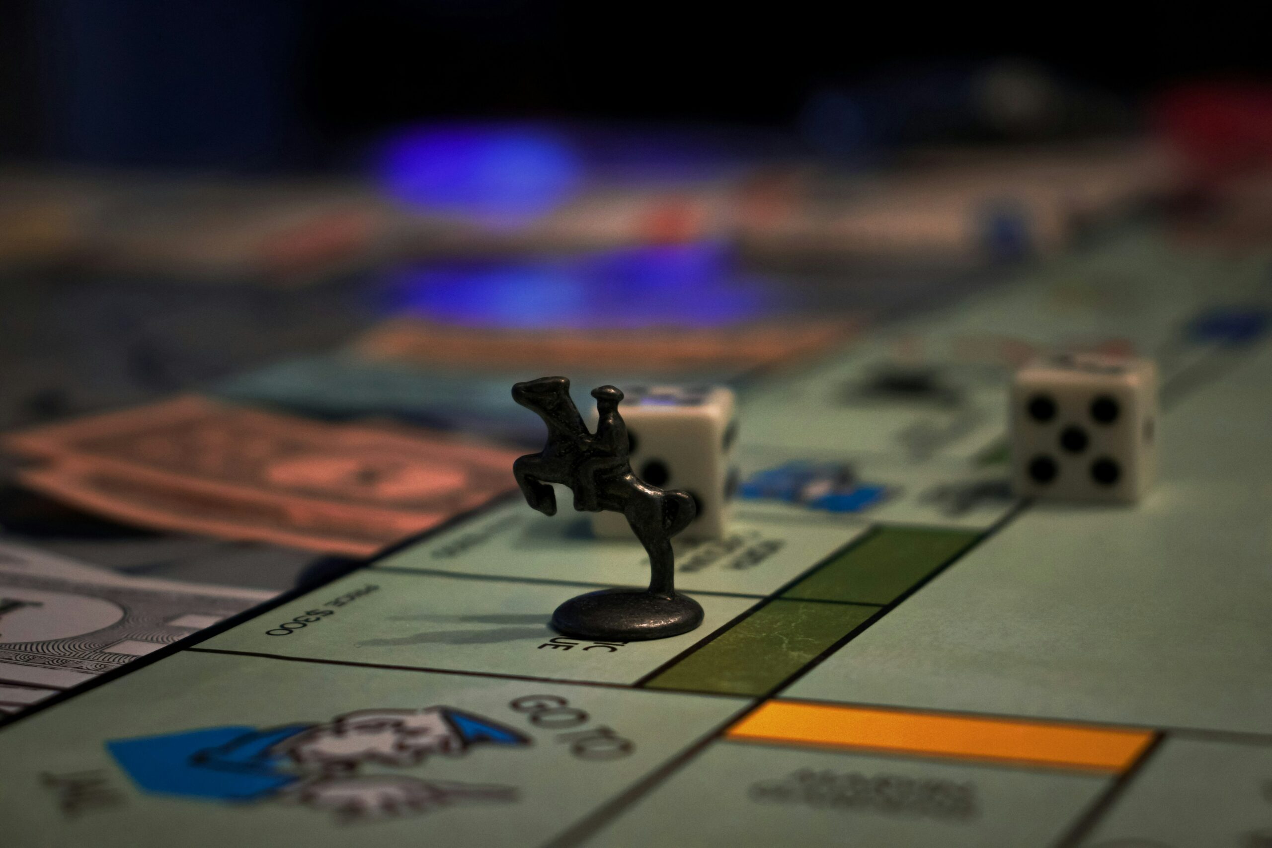 Monopoly board with a black racehorse token sitting on a square